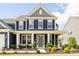 Inviting two-story home featuring a charming front porch with classic design and manicured landscaping at 235 Boxelder Rd, Clover, SC 29710