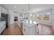 Open kitchen showcasing a large island, stainless steel appliances, sleek countertops, and natural light from large windows at 235 Boxelder Rd, Clover, SC 29710