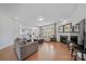 Open-concept living room featuring hardwood floors, fireplace, and seamless integration with kitchen and dining area at 235 Boxelder Rd, Clover, SC 29710