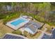 Aerial view of a community pool and clubhouse with ample parking surrounded by lush trees and greenery at 235 Boxelder Rd, Clover, SC 29710