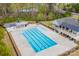 Aerial view of a large pool with blue water and clubhouse showcasing community recreational amenities at 235 Boxelder Rd, Clover, SC 29710