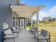 Inviting covered porch with comfortable seating, offering a relaxing outdoor space with view of the backyard at 235 Boxelder Rd, Clover, SC 29710