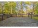 Expansive backyard deck with wooden railings, offering scenic views of the wooded surroundings at 2371 Lazy Oak Dr, Lancaster, SC 29720
