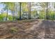 Home's exterior with a deck, large backyard, lush greenery and a shed at 2371 Lazy Oak Dr, Lancaster, SC 29720