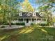 Charming home featuring a spacious porch, dormer windows, and well-maintained landscaping at 2371 Lazy Oak Dr, Lancaster, SC 29720