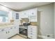 Bright kitchen with white cabinets, stainless steel range and tile floors at 2371 Lazy Oak Dr, Lancaster, SC 29720
