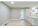 Eat-in kitchen with tiled floors, white cabinets, and a bright window with access to the backyard at 2371 Lazy Oak Dr, Lancaster, SC 29720