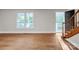 Bright living room featuring hardwood floors, a large window, and stairs leading to the next level at 2371 Lazy Oak Dr, Lancaster, SC 29720