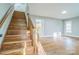 Open-concept room featuring a wooden staircase, hardwood floors, natural light and neutral paint at 2371 Lazy Oak Dr, Lancaster, SC 29720