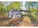Exterior shot of a storage shed with a carport-like extension and fenced backyard at 2371 Lazy Oak Dr, Lancaster, SC 29720