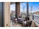 A view of a cozy outdoor balcony featuring a seating area with neutral colored cushions at 2401 Euclid Ave, Charlotte, NC 28203