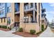 A view of private outdoor balcony featuring stone siding, black railings, and lush landscaping at 2401 Euclid Ave, Charlotte, NC 28203