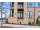 A view of private outdoor balcony featuring stone siding, black railings, and an outdoor seating area at 2401 Euclid Ave, Charlotte, NC 28203