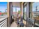 A view of an outdoor balcony featuring black rocking chairs and views of the street at 2401 Euclid Ave, Charlotte, NC 28203