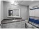 Neutral bathroom featuring a gray vanity with a white vessel sink and shower with a blue and gray curtain at 2401 Euclid Ave, Charlotte, NC 28203