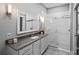 Modern bathroom featuring sleek vanity with stone countertop and glass-enclosed walk-in shower at 2401 Euclid Ave, Charlotte, NC 28203