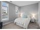 Neutral bedroom with carpet, natural light, a queen bed, white bedding, and two side tables at 2401 Euclid Ave, Charlotte, NC 28203