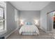 Bright bedroom with large windows, neutral walls, and a comfortable bed dressed in white linens at 2401 Euclid Ave, Charlotte, NC 28203