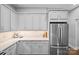 Modern kitchen features grey cabinets, quartz countertops, stainless steel appliances, and subway tile backsplash at 2401 Euclid Ave, Charlotte, NC 28203