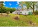 Exterior shot showing the house, white picket fence, shed and lush backyard with green grass at 292 Mocksville Hwy, Statesville, NC 28625
