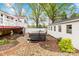 Backyard showcasing a hot tub, an outbuilding, stone pathways, and a white privacy fence at 292 Mocksville Hwy, Statesville, NC 28625
