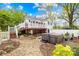 An inviting backyard with a deck, hot tub, stone pathway, and lush landscaping at 292 Mocksville Hwy, Statesville, NC 28625