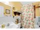 Bright bathroom featuring yellow walls, floral shower curtain, and a tiled shower at 292 Mocksville Hwy, Statesville, NC 28625