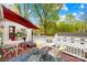 Charming deck with outdoor seating, a red umbrella, and view of trees and sky at 292 Mocksville Hwy, Statesville, NC 28625