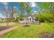 Inviting home with white picket fence, brick pathway and mature trees dotting the landscape at 292 Mocksville Hwy, Statesville, NC 28625