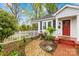 Charming home with a vibrant garden, fountain, and a welcoming red brick entryway at 292 Mocksville Hwy, Statesville, NC 28625