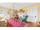 Cozy living room with yellow walls, wood floors, and a red floral area rug at 292 Mocksville Hwy, Statesville, NC 28625