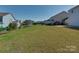 Expansive backyard featuring well-maintained lawn and black metal fence at 317 Contentment Dr, Locust, NC 28097