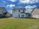 Spacious backyard featuring well-maintained lawn and solar panels on the house at 317 Contentment Dr, Locust, NC 28097