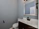 Stylish powder room with a modern vanity, decorative mirror, and sleek black fixtures at 317 Contentment Dr, Locust, NC 28097