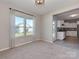 Bedroom with neutral carpet, natural light from the windows and an adjacent kitchen area at 317 Contentment Dr, Locust, NC 28097