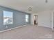 Spacious bedroom with ample natural light from two large windows and neutral color scheme at 317 Contentment Dr, Locust, NC 28097