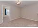 Bedroom featuring neutral carpet, natural light, adjacent room and closet space at 317 Contentment Dr, Locust, NC 28097