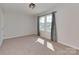Bedroom with plush carpeting, ample light from the window, and neutral gray walls at 317 Contentment Dr, Locust, NC 28097