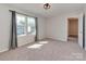 Neutral bedroom with plush carpets and two windows at 317 Contentment Dr, Locust, NC 28097