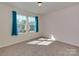 Bedroom featuring ample natural light, plush carpet, and views of the neighborhood at 317 Contentment Dr, Locust, NC 28097