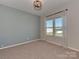 Bright bedroom featuring neutral carpet, two large windows, and soothing wall color for a relaxing atmosphere at 317 Contentment Dr, Locust, NC 28097