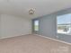 Spacious bedroom with ample natural light, neutral carpet, and soothing paint colors for a peaceful retreat at 317 Contentment Dr, Locust, NC 28097