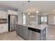 Open concept kitchen boasts an island with stainless steel appliances and flows into the living area at 317 Contentment Dr, Locust, NC 28097