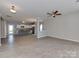 Spacious living room featuring luxury vinyl plank floors, a ceiling fan, and an open layout at 317 Contentment Dr, Locust, NC 28097