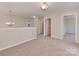 Second floor loft featuring carpet floors, modern lighting, an open layout, and access to multiple rooms at 317 Contentment Dr, Locust, NC 28097