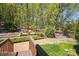Landscaped backyard features a brick patio area surrounded by greenery and mature trees, offering privacy at 3605 Ridgetop Rd, Sherrills Ford, NC 28673