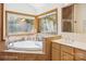 Bathroom featuring a large soaking tub and a wall of windows offering wooded views at 3605 Ridgetop Rd, Sherrills Ford, NC 28673