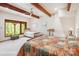 Bedroom featuring white walls and ceiling with wooden beams and a large window at 3605 Ridgetop Rd, Sherrills Ford, NC 28673