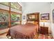 Bright bedroom featuring a large window showcasing wooded views and warm natural light at 3605 Ridgetop Rd, Sherrills Ford, NC 28673