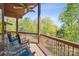 Wooden deck features railing and rocking chairs looking out onto a wooded area at 3605 Ridgetop Rd, Sherrills Ford, NC 28673